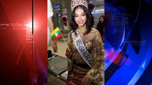 Myanmar model May Myat Noe, the dethroned winner of the Miss Asia Pacific World 2014 pageant, waves a miniature flag of the country upon her arrival at Yangon International Airport in Yangon.   AP