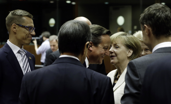 Finnish Prime Minister Alexander Stubb (from left), Cypriot President Nicos Anastasiades, British Prime Minister David Cameron, German Chancellor Angela Merkel and Estonian Prime Minister Taavi Roeivas speak during a round table meeting at an EU summit in Brussels on Saturday.   AP-Yonhap