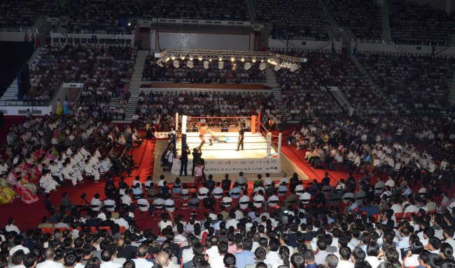 North Koreans watch a pro wrestling exhibition in Pyongyang on Saturday.   Yonhap