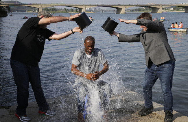 A Grammy award winning rapper and founding member of the Fugees, Pras Michel, gets doused by his friends for the ALS Ice Bucket Challenge, in Pyongyang, North Korea, Sunday.   AP-Yonhap