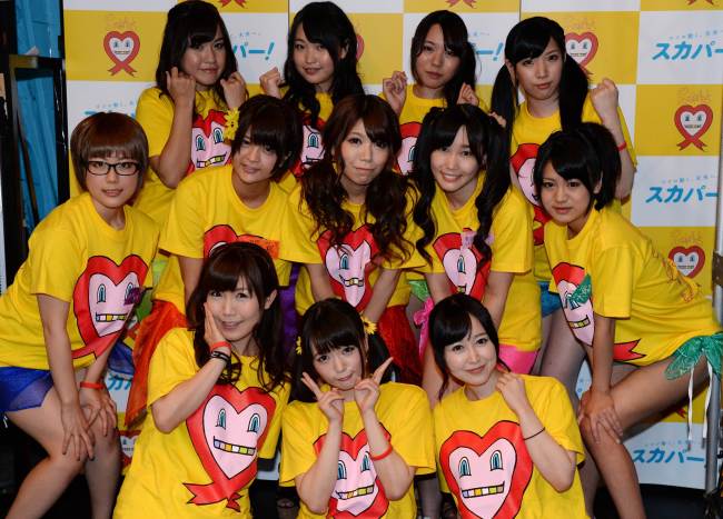 Japanese porn actresses pose with three supporters (front) in Tokyo on Friday, as they were preparing to have their breasts squeezed by fans for 24 hours this weekend for a charity event loosely translated as “Boob Aid.”   AFP-Yonhap