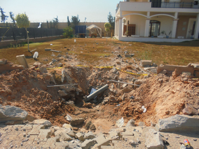 Damage is seen in the front yard of a building at the U.S. Embassy compound in Tripoli on Sunday, after weeks of violence between rival militias over control of the capital.   AP-Yonhap