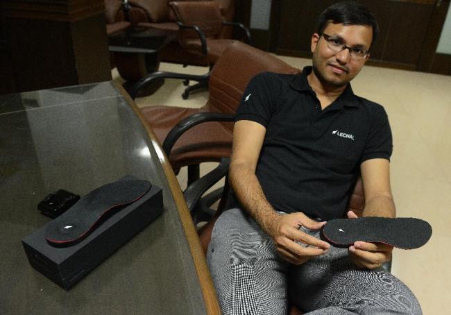 Krispian Lawrence, CEO of Ducere Technologies, holds the inner sole of a pair of GPS-enabled smart sports shoes called LeChal at his office in Hyderabad. (AFP)
