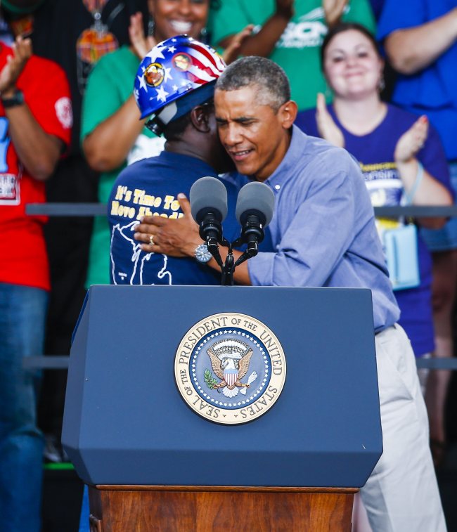 U.S. President Barack Obama embraces steelworker Chris Harris (left) after Harris introduced him at Laborfest 2014 at Henry Maier Festival Park in Milwaukee, Wisconsin, Monday.    EPA-Yonhap