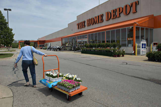 A customer pulls a cart of flowers outside a Home Depot Inc. store in Peoria, Illinois.   Bloomberg