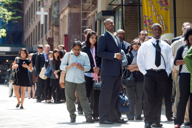 Job seekers line up outside Choice Career Fairs’ New York career fair at the Holiday Inn Midtown in New York.   Bloomberg