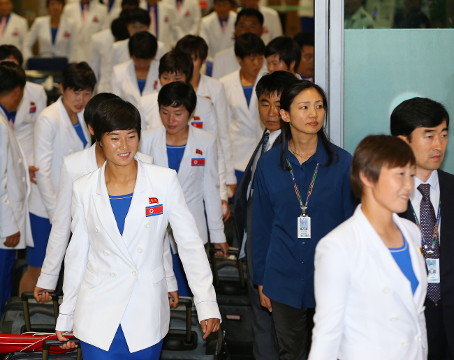 The first batch of 94 members of the North Korean delegation to the Asian Games in South Korea arrives through the Incheon International Airport on Thursday.