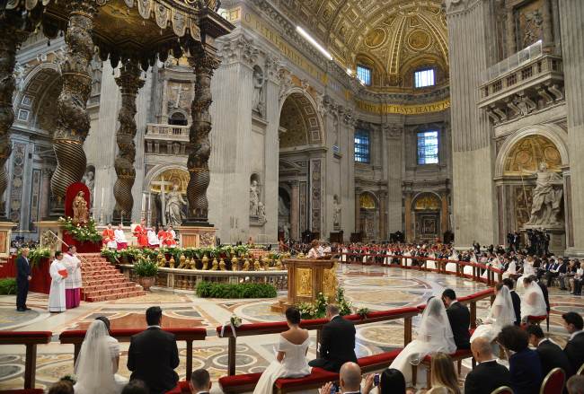Brides and grooms attend their wedding ceremony celebrated as part of a mass by Pope Francis at St Peter’s basilica at the Vatican on Sunday.    AFP-Yonhap