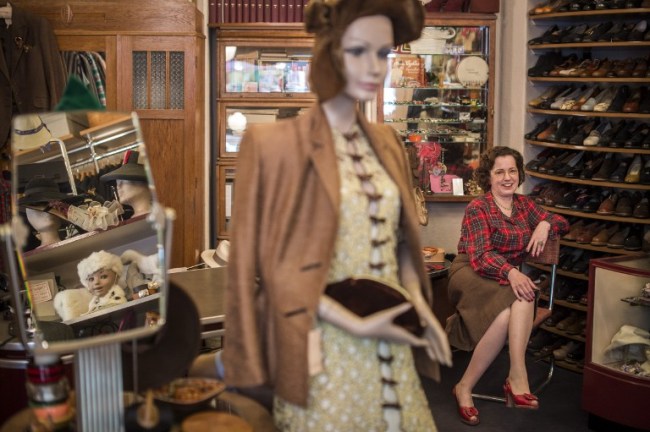 Shop owner Constanze Pelzer, dressed in 1940s vintage garments, sits among clothes and paraphernalia in her 1920s-1950s vintage shop Glencheck in the Wilmersdorf area of Berlin. Pelzer’s boutique, which she said had sourced costumes for World War II films such as “The Reader” and “The Monuments Men,” helps make Berlin a magnet for vintage enthusiasts.   AFP-Yonhap