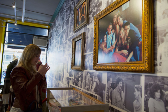 A visitor takes a photograph at the Central Perk coffee shop in New York on Friday.   Bloomberg