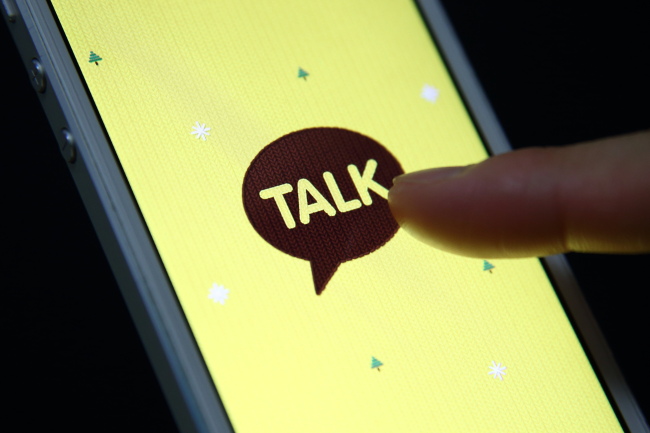 The logo of KakaoTalk, a messaging app developed by Kakao Corp., is displayed on an Apple Inc. iPhone 5 in this arranged photograph taken in Seoul.   Bloomberg