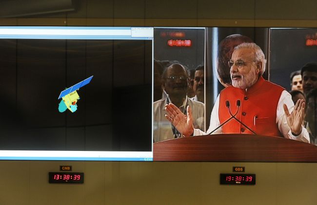 Indian Prime Minister Narendra Modi addresses scientists alongside a graphic of the Mars Orbiter Spacecraft on Wednesday.   AFP-Yonhap