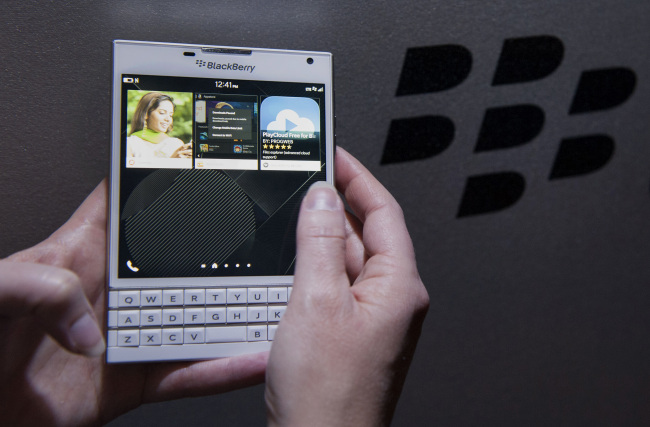 An attendee demonstrates a BlackBerry Ltd. Passport smartphone during a product announcement in Toronto, Ontario, Canada, on Wednesday, Sept. 24, 2014. The square-screened Passport is BlackBerry's first major new device slated for a global introduction since Chief Executive Officer John Chen set out in November to turn around the company by shifting away from the consumer market toward business and professional users. Photographer: Hannah Yoon/Bloomberg
An attendee demonstrates a BlackBerry Passport smartphone during a product announcement in Toronto, Ontario, Canada, Wednesday.   Bloomberg