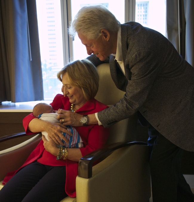Former Secretary of State Hillary Rodham Clinton (left) and former President Bill Clinton with their granddaughter Charlotte Clinton Mezvinsky on Saturday.   AP-Yonhap