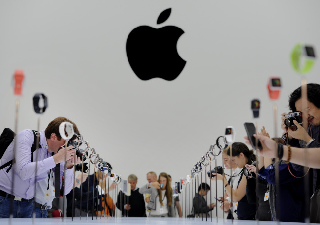 Attendees photograph the Apple Watch after a product announcement at the Flint Center in Cupertino, California, Sept. 9.   Bloomberg