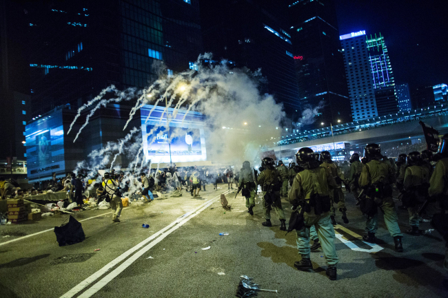 Police fire tear gas at demonstrators during a protest near central government offices in Hong Kong on Sunday.   Bloomberg