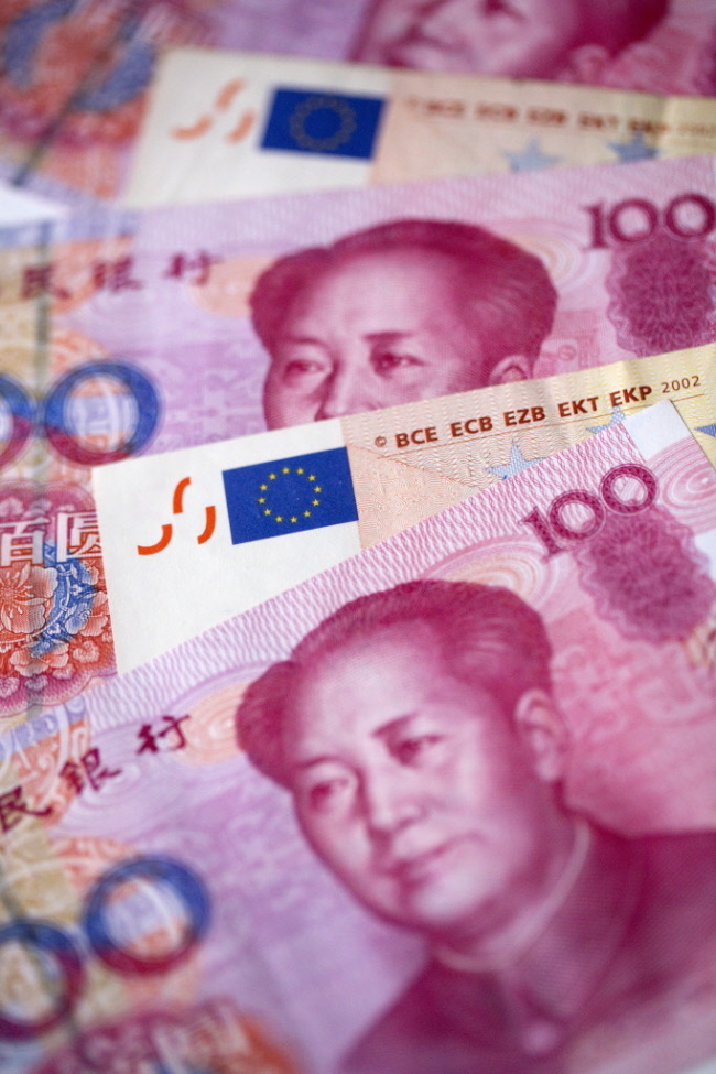 Yuan and euro banknotes.    Bloomberg
