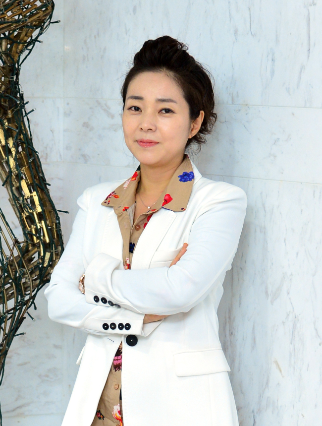 Conductor Kim Bong-mee. Yoon Byung-chan/The Korea Herald