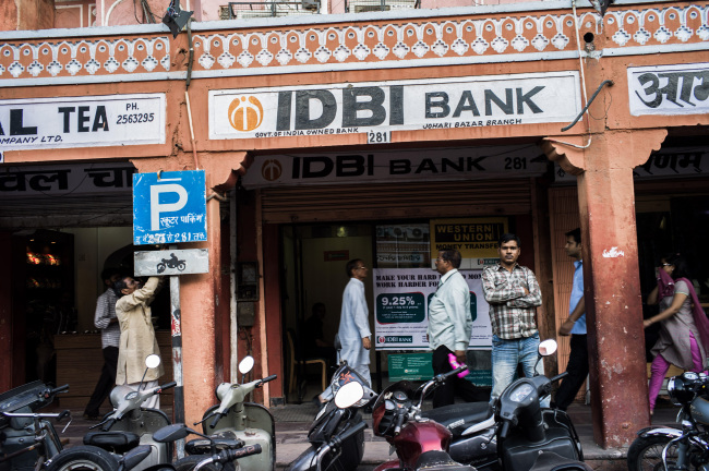 Pedestrians walk past an IDBI Bank branch in Jaipur, Rajasthan, India.   Bloomberg