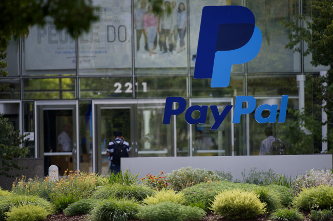 PayPal signage is displayed in front of eBay Inc. headquarters in San Jose, California, U.S., on Tuesday, Sept. 30, 2014. EBay Inc. is spinning off its PayPal division, heeding demands by activist shareholder Carl Icahn and giving the business independence it can use to contend with rising competition from Apple Inc. and Google Inc. Photographer: David Paul Morris/Bloomberg
PayPal signage is displayed in front of eBay’s headquarters in San Jose, California.    Bloomberg