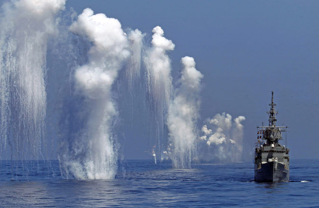The Taiwan Navy’s Perry-class frigate fires chaff during the annual Han Kuang military exercises off the east coast of Hualien, central Taiwan, Sept. 17.   AP-Yonhap