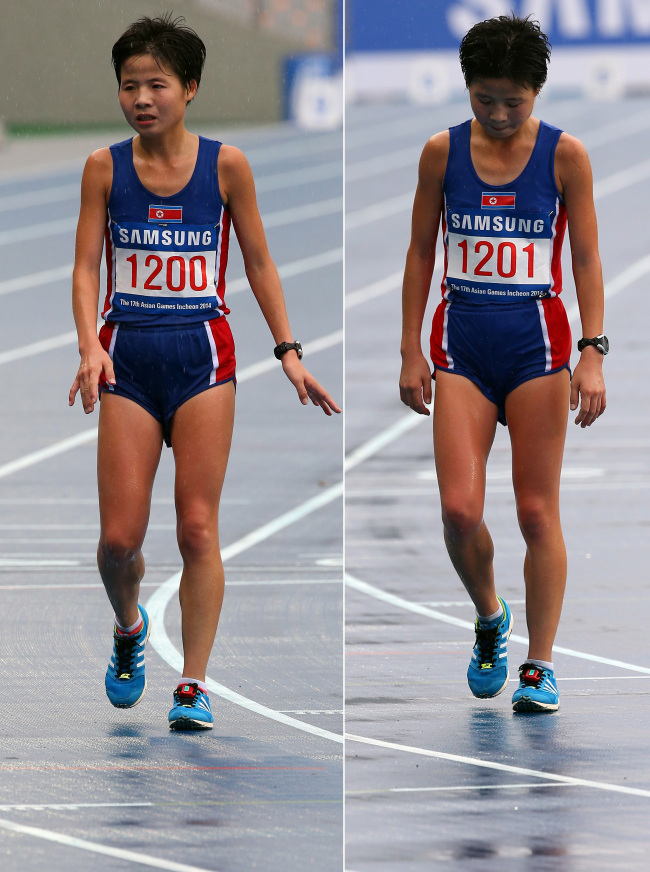 North Korean twin runners Kim Hye-gyong (left) and Kim Hye-song appear disappointed after racing at the Asian Games on Thursday. (Yonhap)