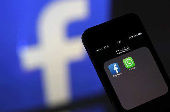 The Facebook and WhatsApp applications’ icons are displayed on an iPhone in London.   Bloomberg