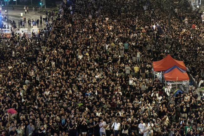 Pro-democracy demonstrators gather for a night rally in Hong Kong on Saturday.   AFP-Yonhap