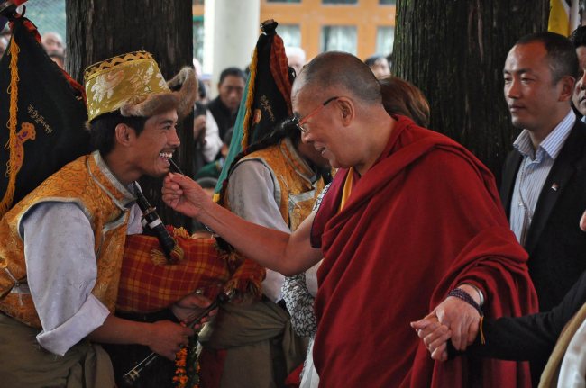 Dalai Lama (right) greets musicians during an event at the Main Tibetan Tsuglagkhang Temple in McLeod Ganj near Dharamsala, India.   EPA-Yonhap