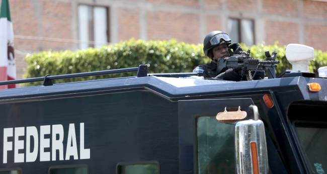 A federal police officer patrols in downtown Iguala, Guerrero state, Mexico, Monday.   AFP-Yonhap