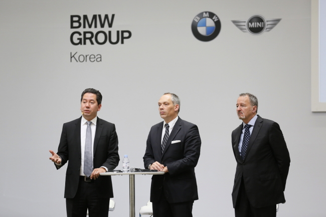 (From left) Glenn Schmidt, Asian director of corporate and government affairs, Julian Weber, head of innovation projects e-mobility, and Bill McAndrews, vice president of communications strategy, talk with university students at a session of the e-mobility forum held at BMW Driving Center on Yeongjongdo Island in Incheon on Tuesday.   BMW Korea