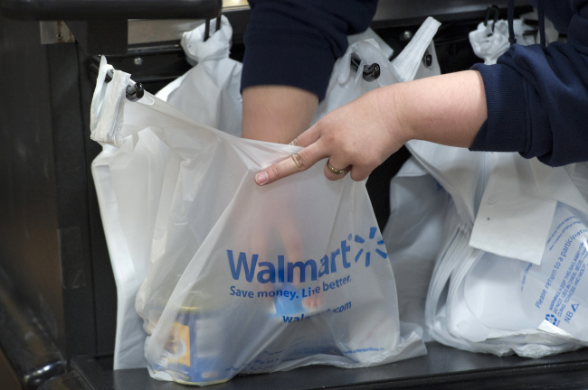 An employee bags merchandise at a Wal-Mart store in American Canyon, California.    Bloomberg