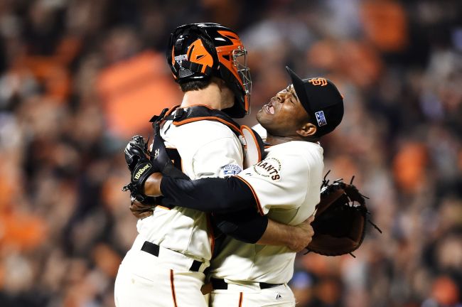 Santiago Casilla (right) and Buster Posey of the San Francisco Giants celebrate after the final out of their 3 to 2 win over the Washington Nationals on Tuesday.    AFP-Yonhap