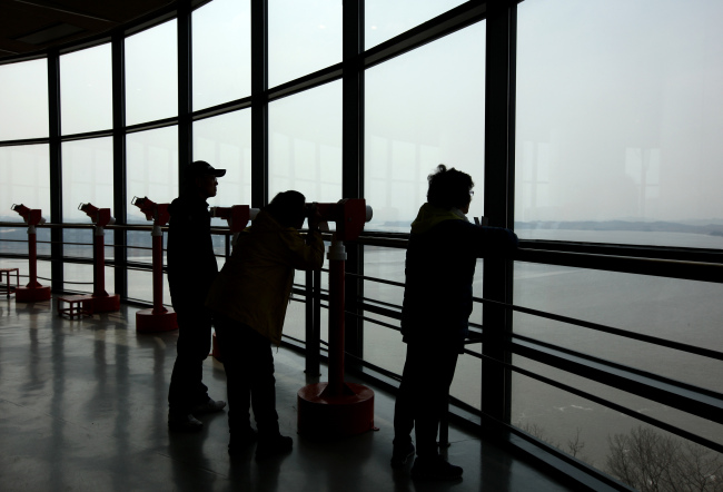 Visitors look towards the North Korean village at the Odusan Unification Observatory near the DMZ in Paju.  (Bloomberg)