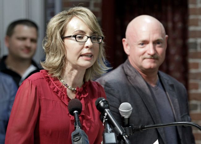 Former Arizona Rep. Gabrielle Giffords, accompanied by her husband, retired astronaut and combat veteran Capt. Mark Kelly, speaks during a news conference at the Millyard Museum in Manchester, New Hampshire, in July 2013.   AP-Yonhap