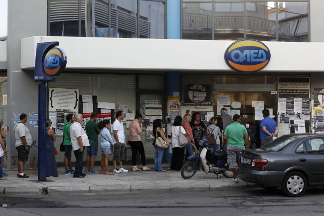 Job seekers wait for an employment center to open in Athens.   Bloomberg