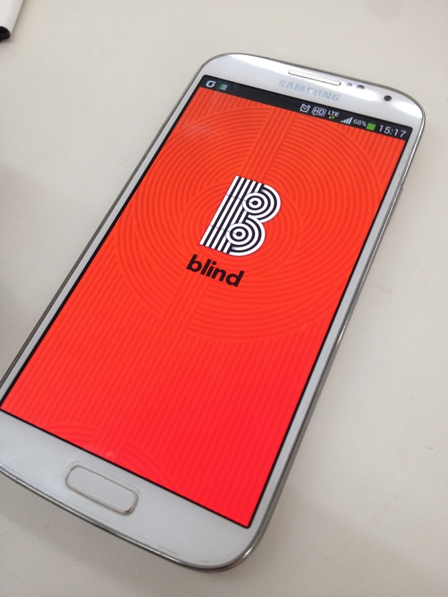 A mobile phone running a Blind message board application.   Team Blind
