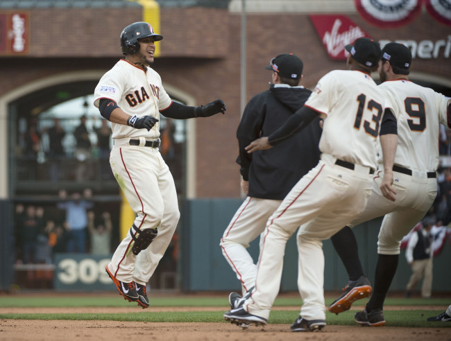 The San Francisco Giants’ Gregor Blanco (left) celebrates after his 10th-inning bunt scored Brandon Crawford.   MCT