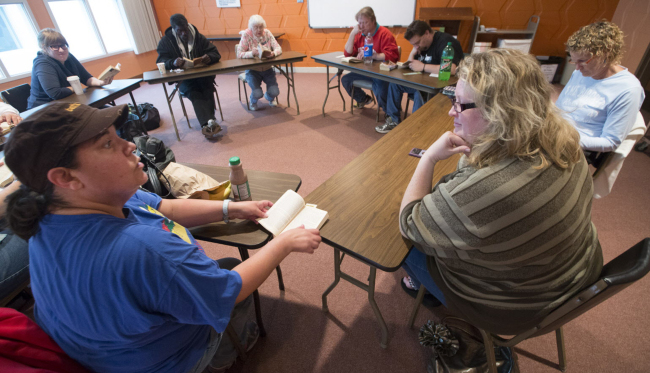 Linda Hansen (left) talks with discussion leader Dannelle Gay (right) during a book club gathering for the homeless on Sept. 30, 2014, at Bethel Lutheran Church in Madison, Wisconsin.    MCT