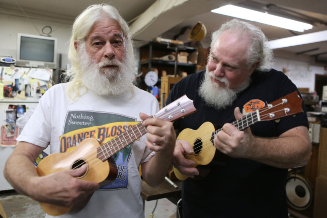 Owners Bill Fels (right) and Doug Montgomery build and repair guitars at the Guitar Factory in Orlando, Florida.   MCT