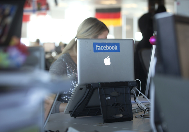 An Apple’s laptop computer with the Facebook logo is on display at the offices of Facebook’s European headquarters at Hanover Quay in Dublin, Ireland.   Bloomberg