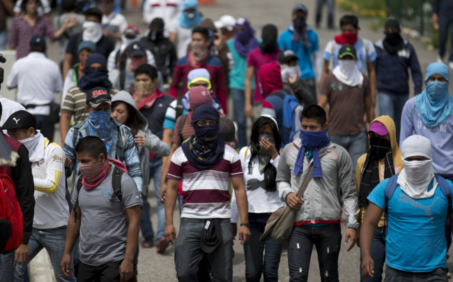 Masked students block a main highway to protest the disappearance of 43 missing college students, in Chilpancingo, Mexico, Wednesday.   AP-Yonhap