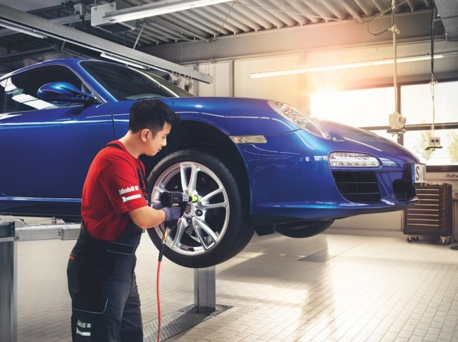 A technician works on a Porsche 911 at a workshop in Seoul.   Porsche Korea