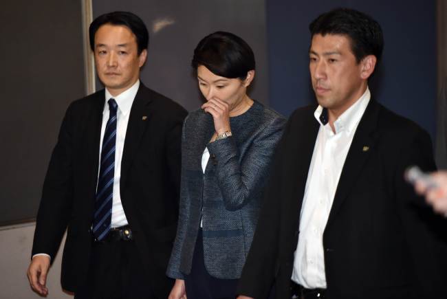 Japanese Economy, Trade and Industry Minister Yuko Obuchi (center) leaves her office in Tokyo on Saturday.   AFP-Yonhap