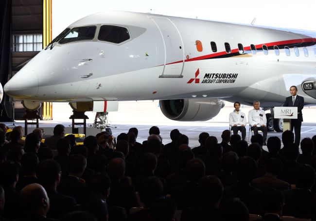 All Nippon Airways CEO and president Shinichiro Ito (right) delivers a speech alongside Mitsubishi Aircraft president Teruaki Kawai (third from right) and Mitsubishi Heavy Industries chairman Hideaki Omiya (second from right) during a ceremony for the Mitsubishi Regional Jet at Nagoya Airport in Komaki, Aichi prefecture, Saturday.    AFP-Yonhap