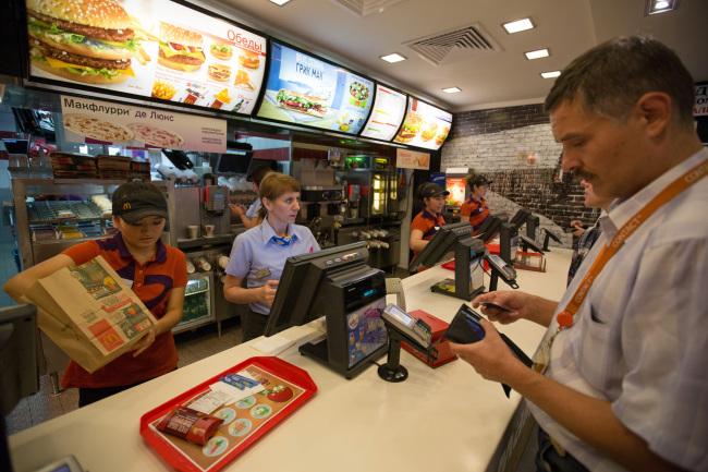 Employees serve customers at the payment counter of a McDonald’s in Moscow.   Bloomberg
Employees serve customers at the payment counter of a McDonald’s in Moscow.   Bloomberg
Employees serve customers at the payment counter of a McDonald’s in Moscow.   Bloomberg
Employees serve customers at the payment counter of a McDonald’s in Moscow.   Bloomberg
Employees serve customers at the payment counter of a McDonald’s in Moscow.   Bloomberg