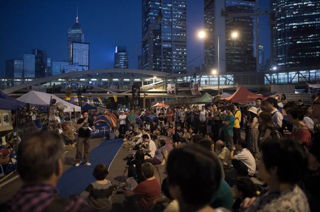 A pro-democracy demonstrator talks to a crowd in the Admiralty district of Hong Kong on Monday.   AFP-Yonhap