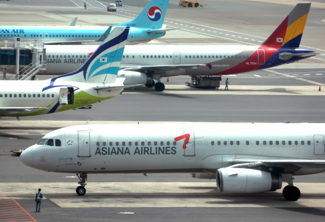 Asiana Airlines passenger jets parked at Incheon International Airport.   Bloomberg