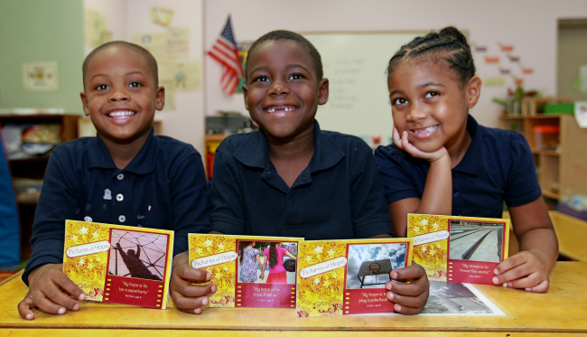 (
From left) Tae’Marr Tubbs, 5, Logan Reed, 6, and
Asia Pagan, 6, hold up the greeting cards that were
made with their photos and words of inspiration in
Philadelphia on Oct. 15. They are called “Pictures of
Hope.” (Philadelphia Inquirer/MCT)
