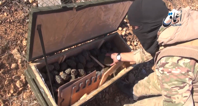 This frame grab from undated video uploaded by militants shows an Islamic State group militant looking through some items from a seized cache of weapons airdropped by U.S.-led coalition forces.   AP-Yonhap
